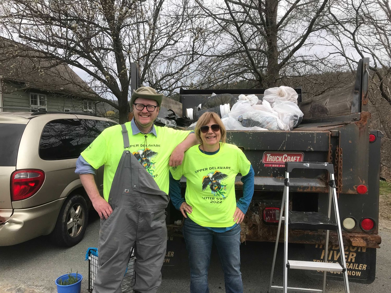 Alan Carroll from Sullivan Renaissance, left, and Wendy from the Narrowsburg Beautification Group pose before a truck of collected trash at the Tusten chapter of the Upper Delaware Council's 2022 Upper Delaware Litter Sweep.